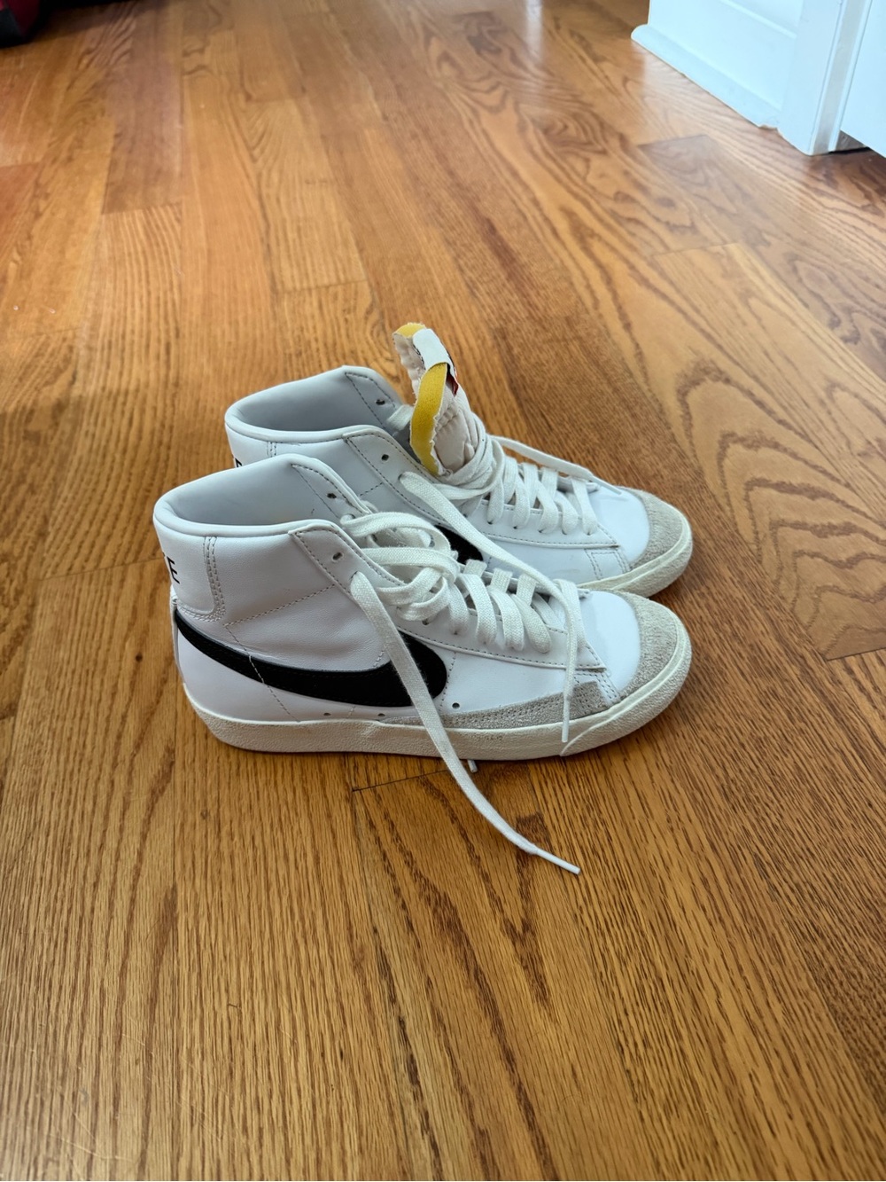 Nike Kids White High-Top Sneakers with Black Swoosh and Yellow Tongue Tab